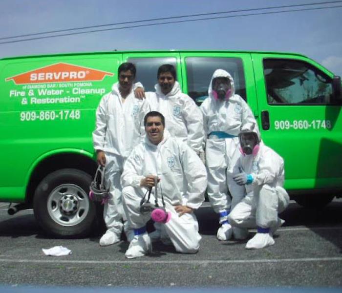 SERVPRO team posing infront of a SERVPRO vehicle. 