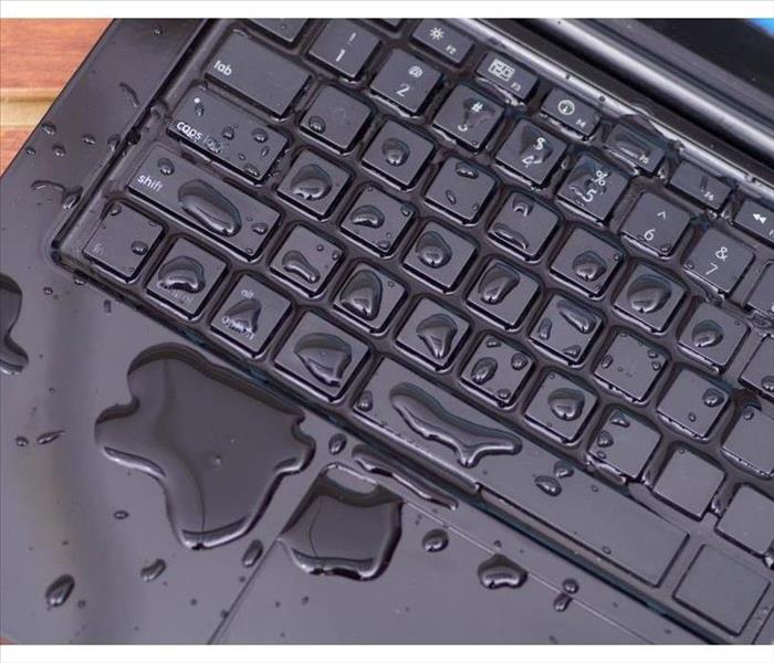 Above view of laptop with water drop damage liquid wet and spill on keyboard, accident concept